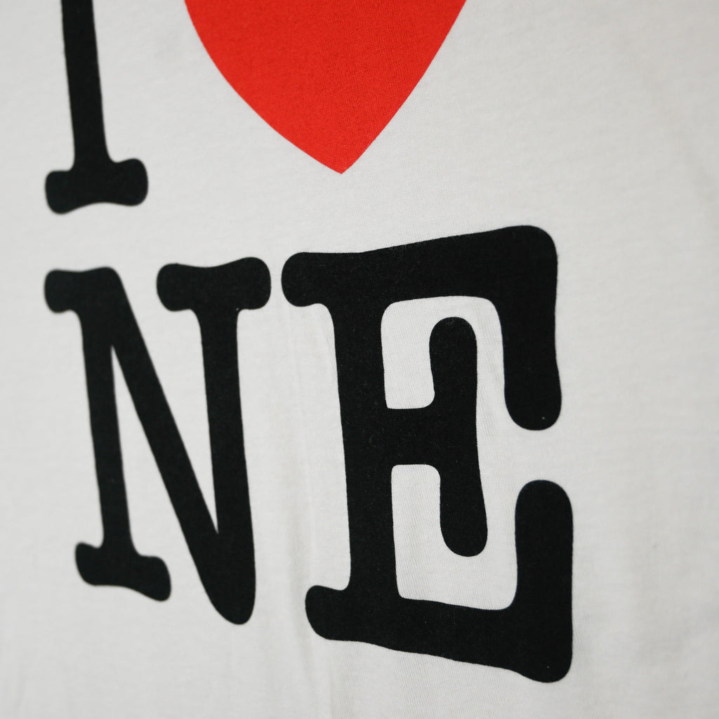 Close-up of black NE typography on I Love NE shirt