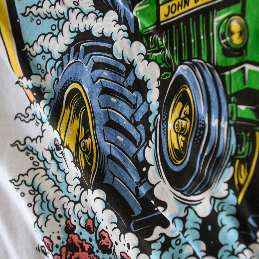 Close-up of tractor wheels on white Nebraska Corn Fiend tee
