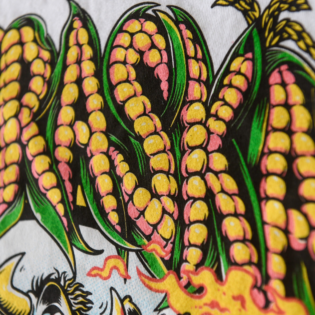 Close-up of yellow corn and green husks in Nebraska back graphic