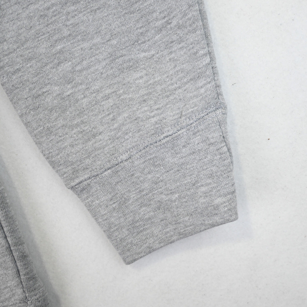 Ribbed sleeve cuff and heather gray sweatshirt fabric close-up