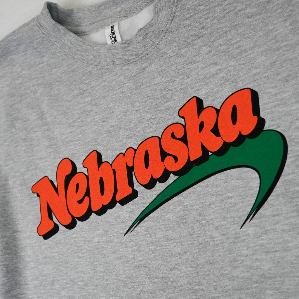 Vintage-style orange and green Nebraska chest print on heather gray sweatshirt