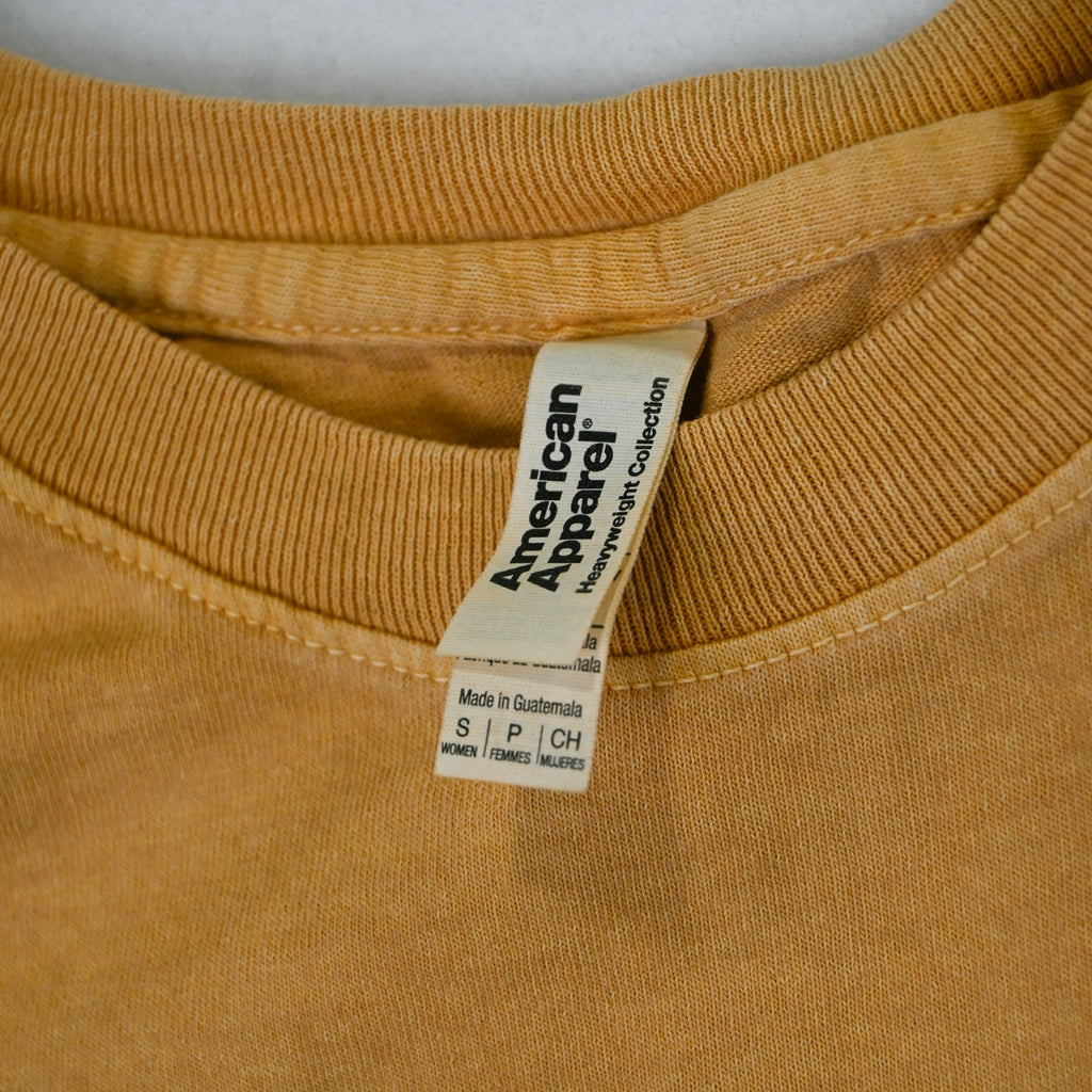 American Apparel Heavyweight Collection neck label on tan tee