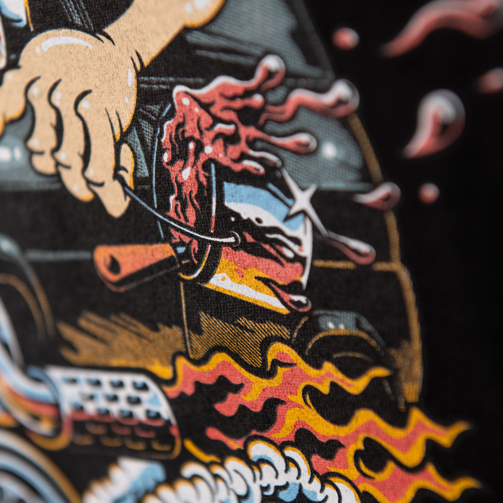 Detail of orange flames and flying red ink in black t-shirt back print