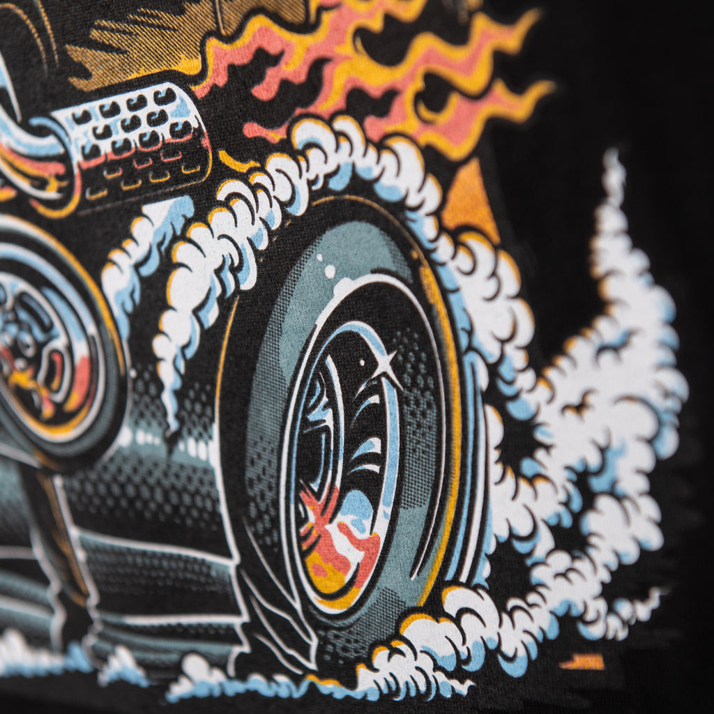 Close-up of illustrated van tire, smoke and flames on black shirt