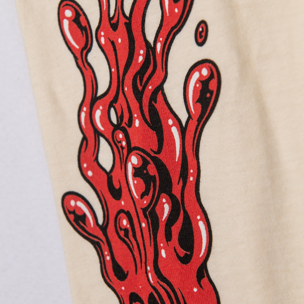 Close-up of red ink-splash screen print on Tultex long sleeve