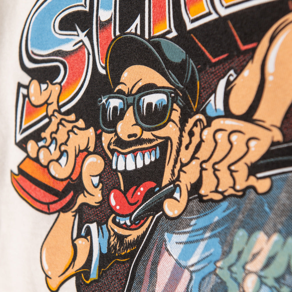 Close-up of cartoon driver in oversized back graphic of cream ringer t-shirt