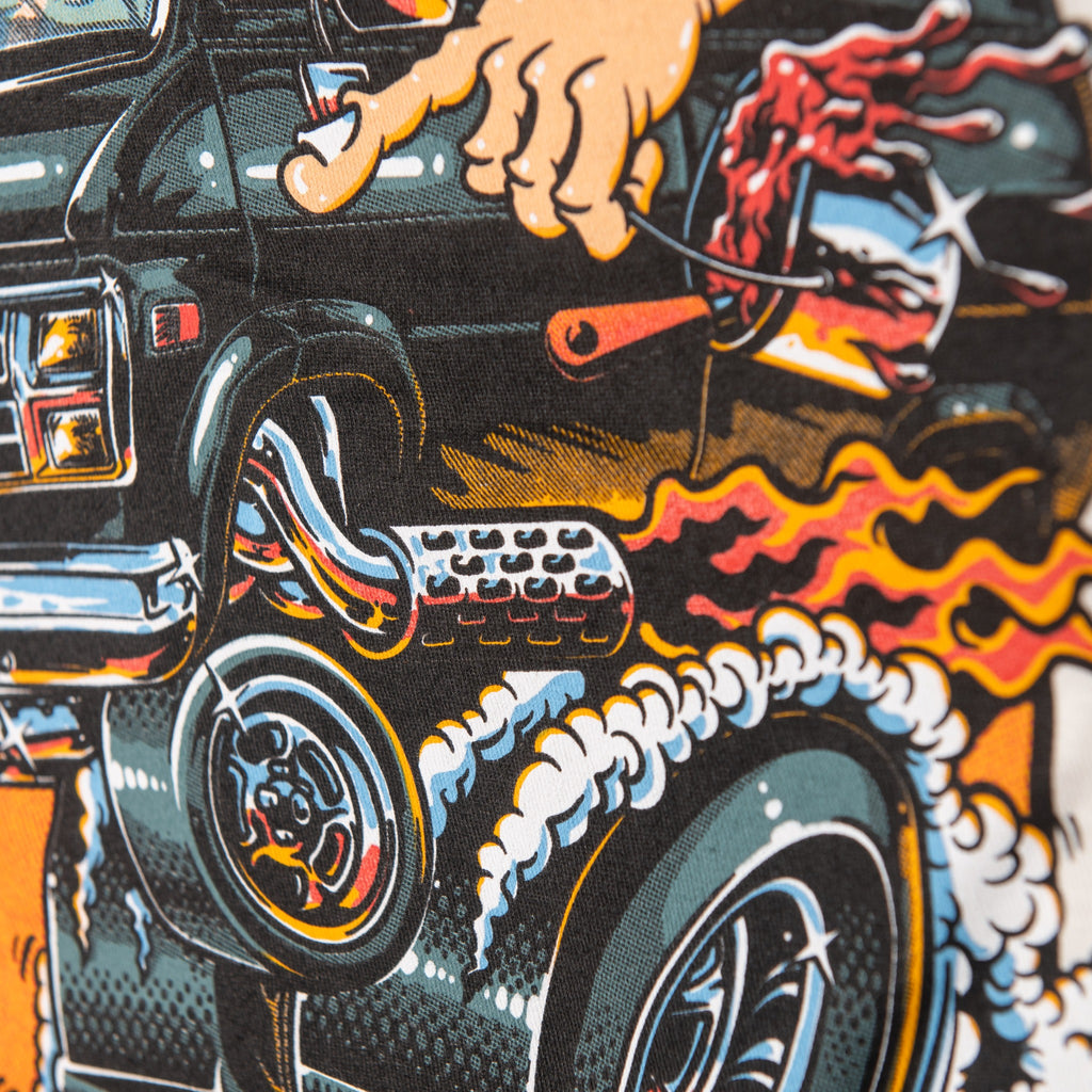 Detail of van wheels, flames and billowing smoke in ringer tee back print